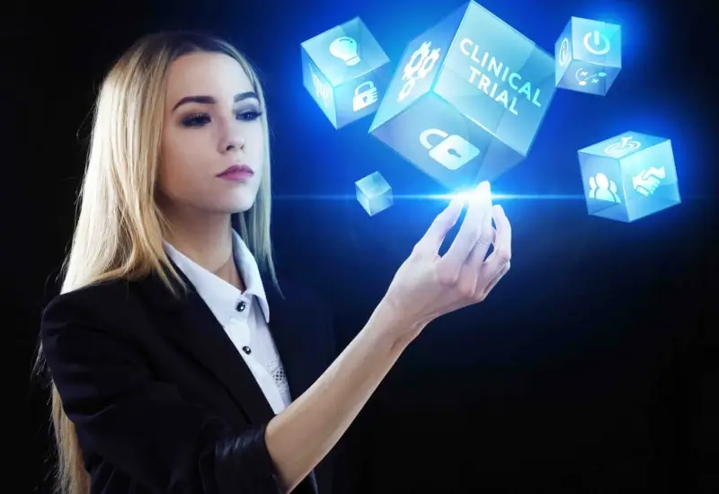 A blonde woman with glowing cubes at the tips of her right hand fingers